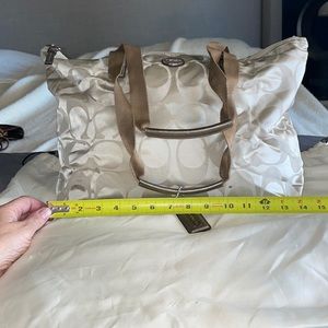 Coach duffle champagne color exterior w/ soft pink interior